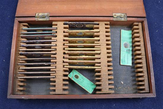 A cased microscope and a cased set of microscope slides